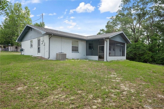 6580 E Glencoe St, Inverness, FL 34452 - rear view of property featuring a sunroom, central air condition unit, and a yard