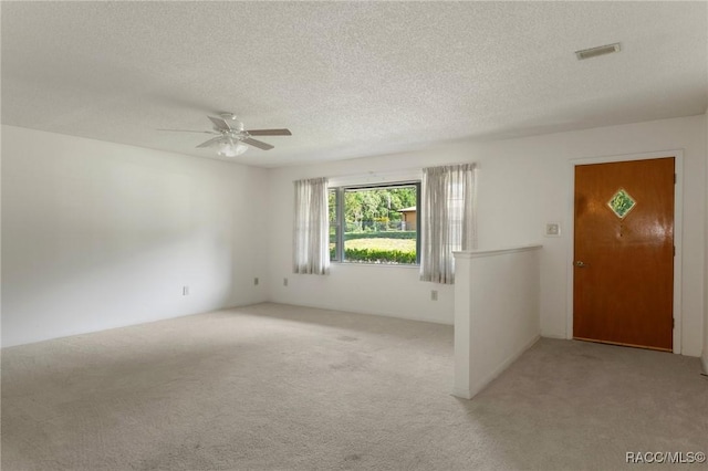 6580 E Glencoe St, Inverness, FL 34452 - unfurnished room with light colored carpet, a ceiling fan, and a textured ceiling