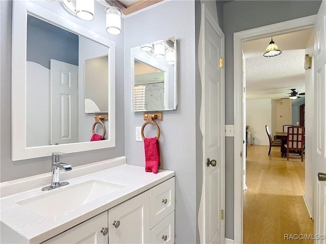 2582 W Fairway Loop, Citrus Springs, FL 34434 - bathroom featuring a ceiling fan, vanity, wood finished floors, and a textured ceiling