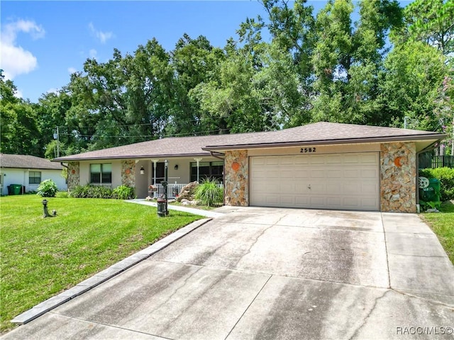 2582 W Fairway Loop, Citrus Springs, FL 34434 - ranch-style house featuring an attached garage, stone siding, a front yard, concrete driveway, and view of scattered trees