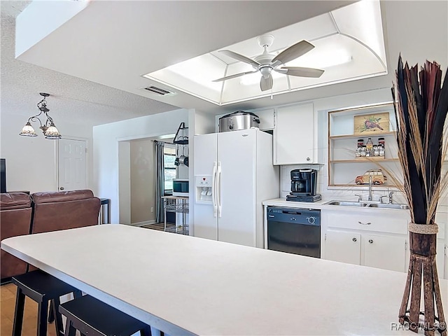 2582 W Fairway Loop, Citrus Springs, FL 34434 - kitchen with black dishwasher, white refrigerator with ice dispenser, white cabinets, a ceiling fan, and light countertops