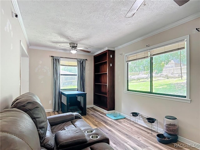 2582 W Fairway Loop, Citrus Springs, FL 34434 - sitting room with light wood-type flooring, a textured ceiling, ceiling fan, and ornamental molding