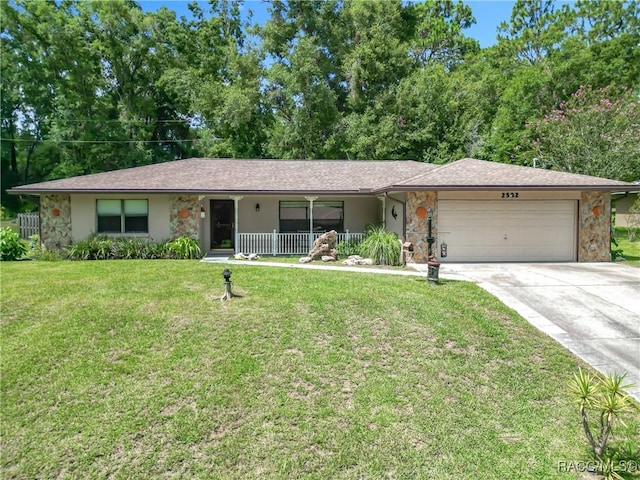 2582 W Fairway Loop, Citrus Springs, FL 34434 - ranch-style house with covered porch, a garage, driveway, stone siding, and a front lawn
