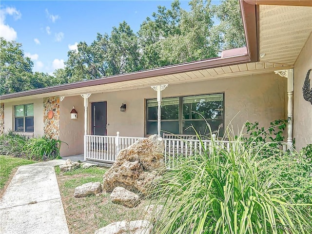 2582 W Fairway Loop, Citrus Springs, FL 34434 - view of front facade featuring covered porch and stucco siding