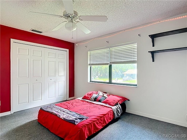 2582 W Fairway Loop, Citrus Springs, FL 34434 - carpeted bedroom featuring a textured ceiling, a closet, and a ceiling fan