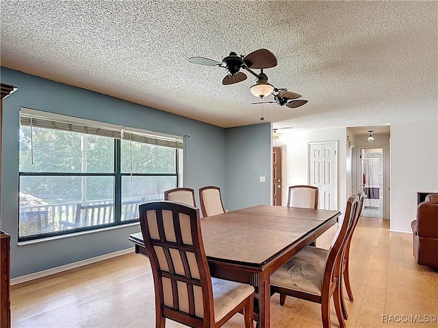 2582 W Fairway Loop, Citrus Springs, FL 34434 - dining area featuring a textured ceiling, ceiling fan, and light wood finished floors