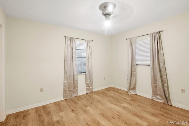 unfurnished room with ceiling fan and light hardwood / wood-style flooring