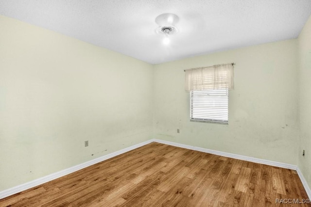 spare room with wood-type flooring