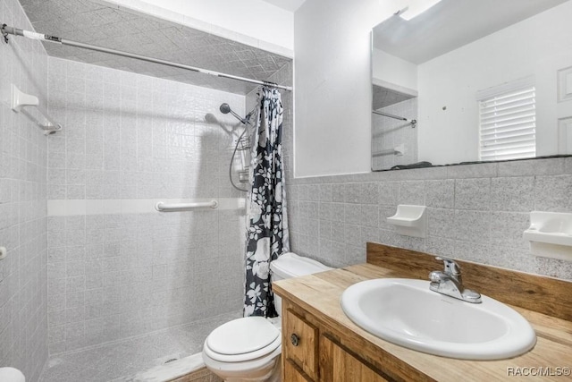 bathroom featuring a shower with shower curtain, vanity, toilet, and tile walls