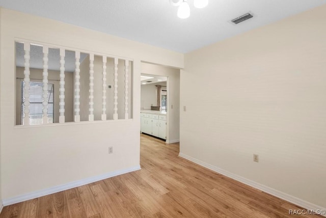 unfurnished room with light hardwood / wood-style floors