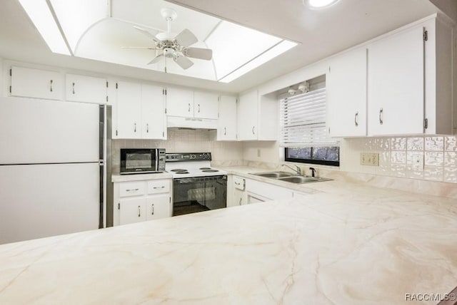 kitchen featuring sink, electric range, tasteful backsplash, white fridge, and white cabinetry