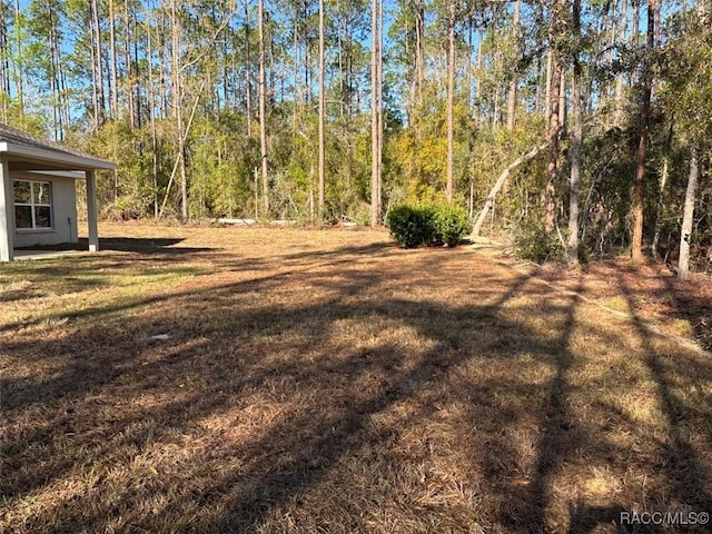 view of yard with a wooded view