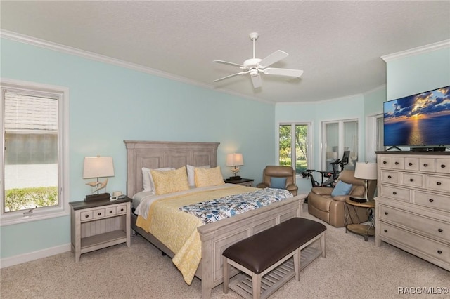 bedroom featuring ceiling fan, ornamental molding, light colored carpet, and a textured ceiling