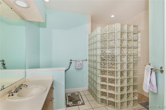 bathroom with vanity, tile patterned floors, and walk in shower