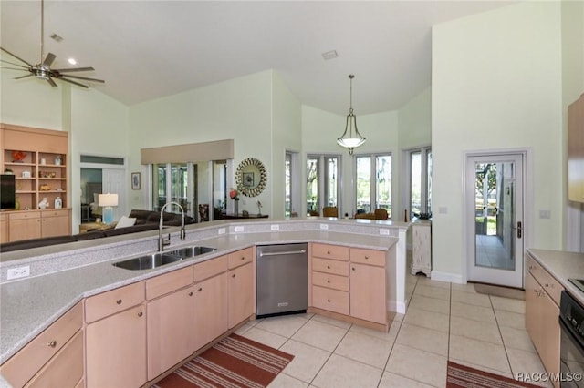 kitchen featuring sink, light tile patterned floors, light brown cabinetry, decorative light fixtures, and stainless steel dishwasher