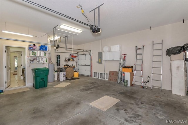 garage featuring a garage door opener and electric panel