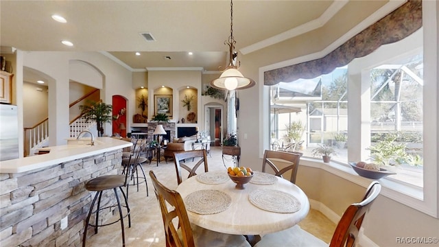 dining room featuring visible vents, arched walkways, crown molding, and recessed lighting