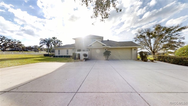 traditional-style home with driveway, a front lawn, an attached garage, and stucco siding