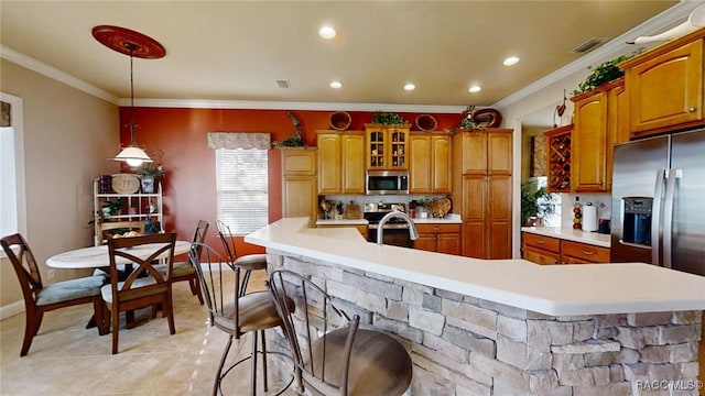 kitchen featuring visible vents, stainless steel appliances, crown molding, a large island with sink, and light countertops