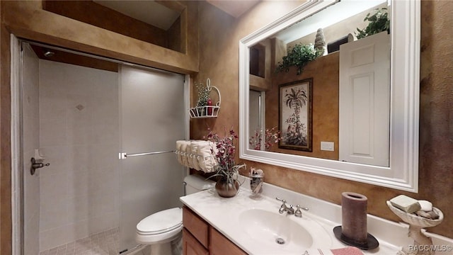 full bathroom with toilet, a shower stall, and vanity