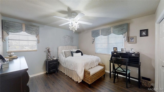 bedroom with a ceiling fan, baseboards, and dark wood-style flooring