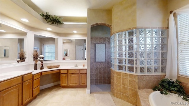 bathroom featuring a walk in shower, recessed lighting, a sink, tile patterned floors, and double vanity