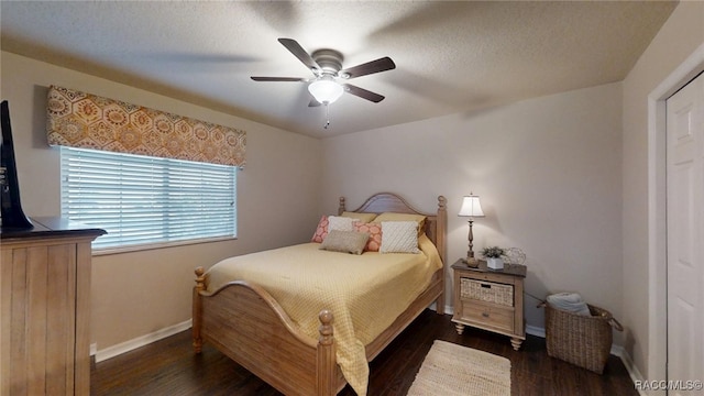 bedroom featuring ceiling fan, a textured ceiling, baseboards, and wood finished floors