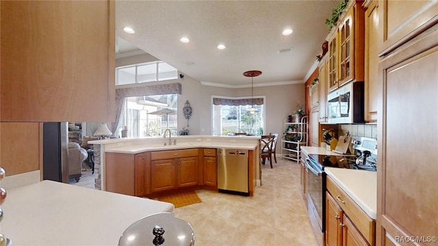 kitchen with crown molding, light countertops, decorative backsplash, appliances with stainless steel finishes, and a sink