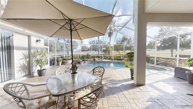 view of patio / terrace featuring glass enclosure and an outdoor pool