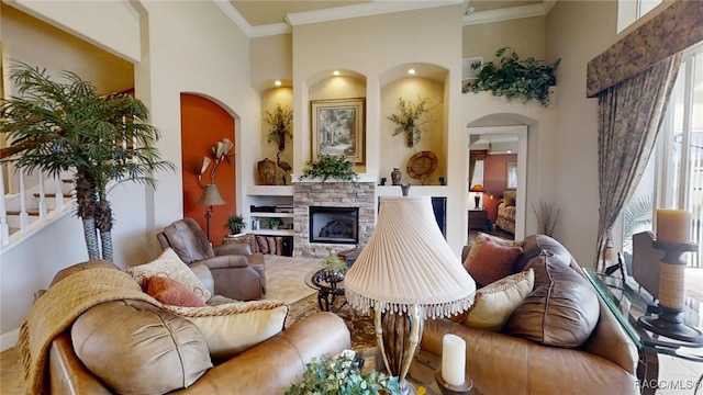 living room featuring ornamental molding, a fireplace, and a high ceiling