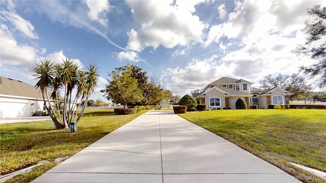 view of front of home with driveway and a front lawn