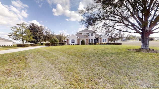 view of front facade with stone siding and a front lawn