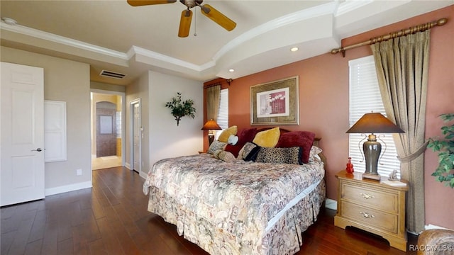 bedroom with baseboards, visible vents, dark wood finished floors, and crown molding