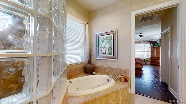 bathroom with visible vents, ensuite bath, and a tub with jets