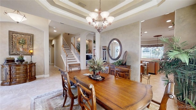 dining space featuring a chandelier, visible vents, stairway, a raised ceiling, and crown molding