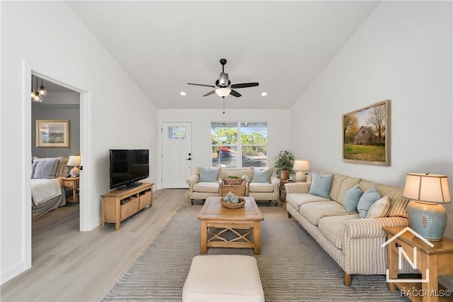 living room featuring ceiling fan and hardwood / wood-style flooring