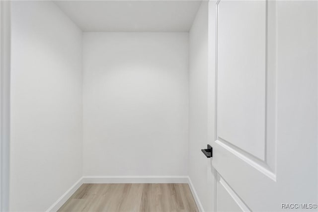 interior space with wood finished floors and baseboards