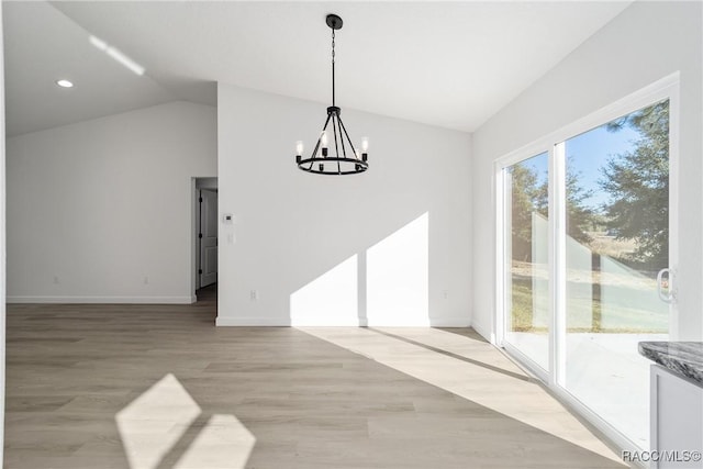 unfurnished dining area with a notable chandelier, lofted ceiling, recessed lighting, light wood-type flooring, and baseboards