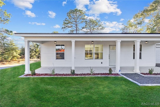 view of exterior entry with a lawn