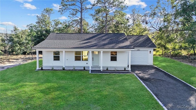 view of front of home featuring a garage, aphalt driveway, and a front lawn