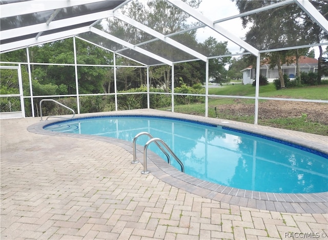 view of pool with a lanai and a patio area