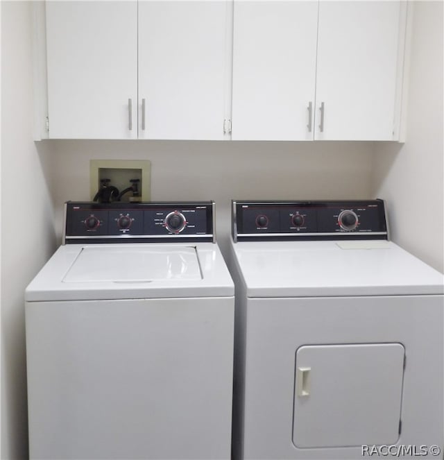 laundry area with cabinets and separate washer and dryer