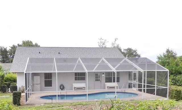 rear view of property with a lanai and a patio