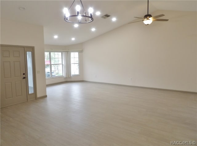 interior space featuring ceiling fan with notable chandelier, light hardwood / wood-style floors, and lofted ceiling