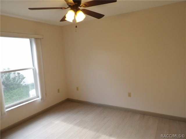 unfurnished room featuring ceiling fan, a healthy amount of sunlight, and light hardwood / wood-style floors