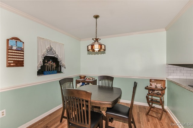 dining room featuring crown molding and wood-type flooring