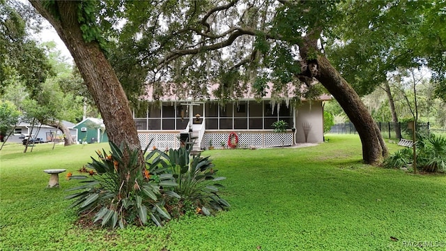 view of yard with a sunroom