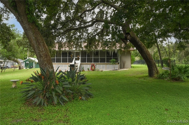 view of yard with a sunroom