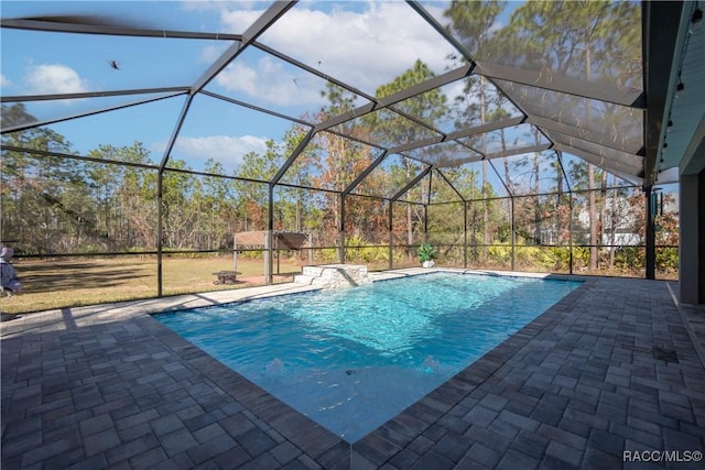 view of swimming pool featuring pool water feature, a lanai, and a patio area