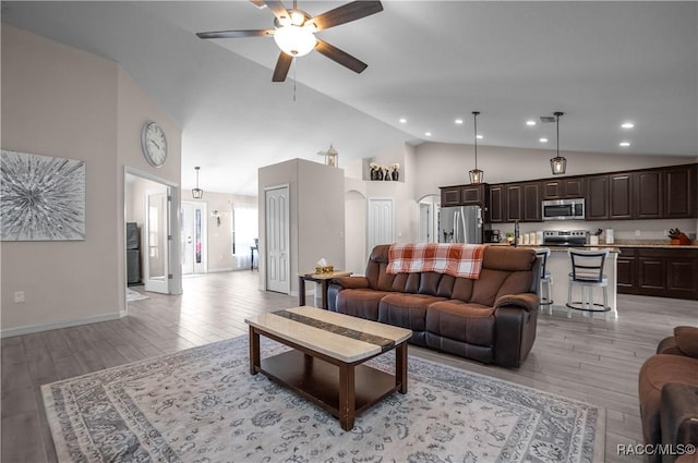 living room with ceiling fan and high vaulted ceiling